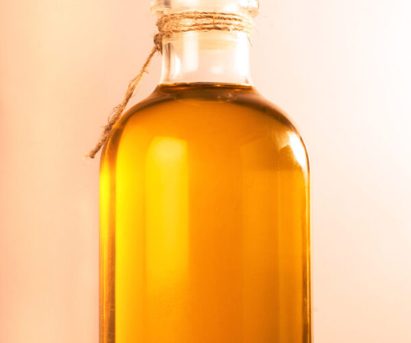 Bottle with  oil on a wooden surface